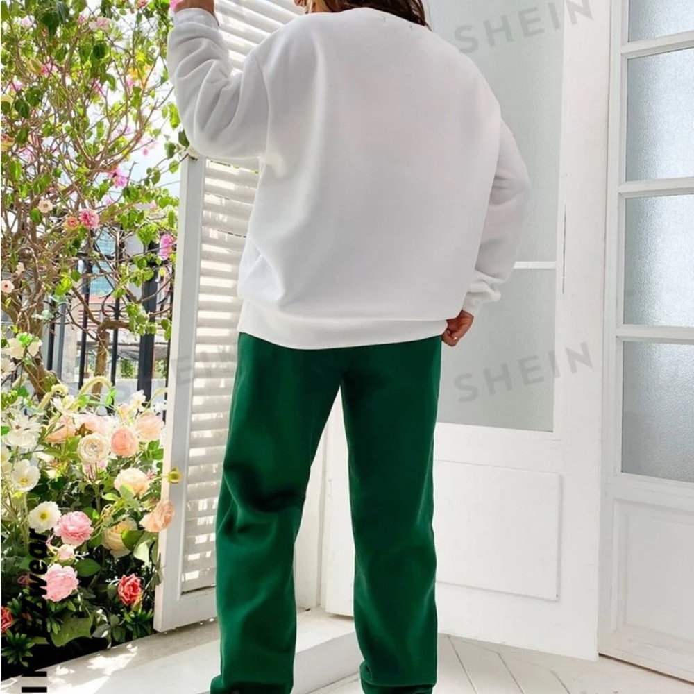 white sweatshirt with green print and green sweatpants